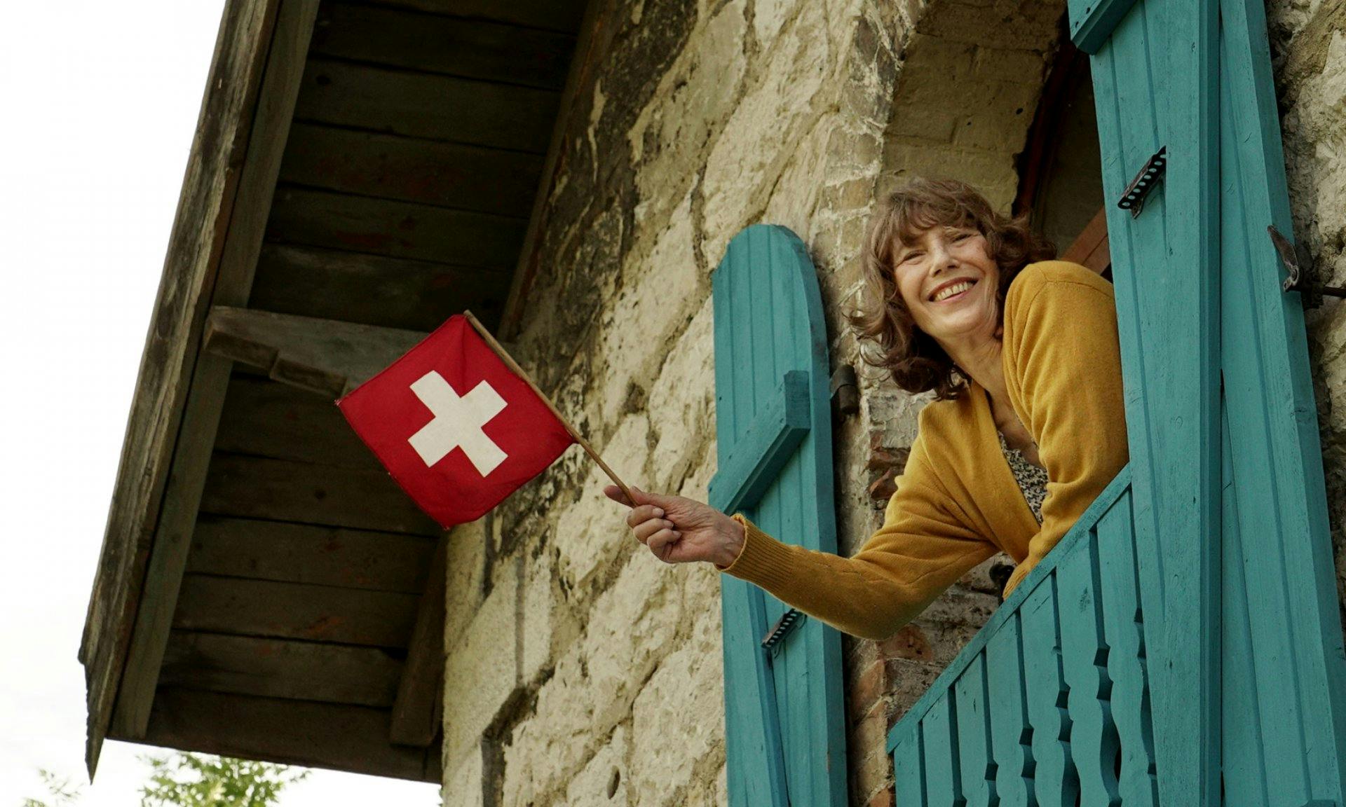 L'actrice et chanteuse britannique tient un drapeau suisse.